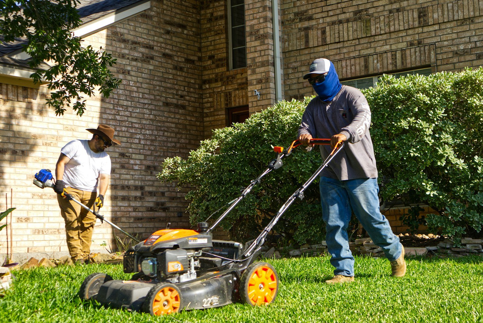 Commercial mower cutting a striped residential lawn by KP Landscaping in Buffalo NY
