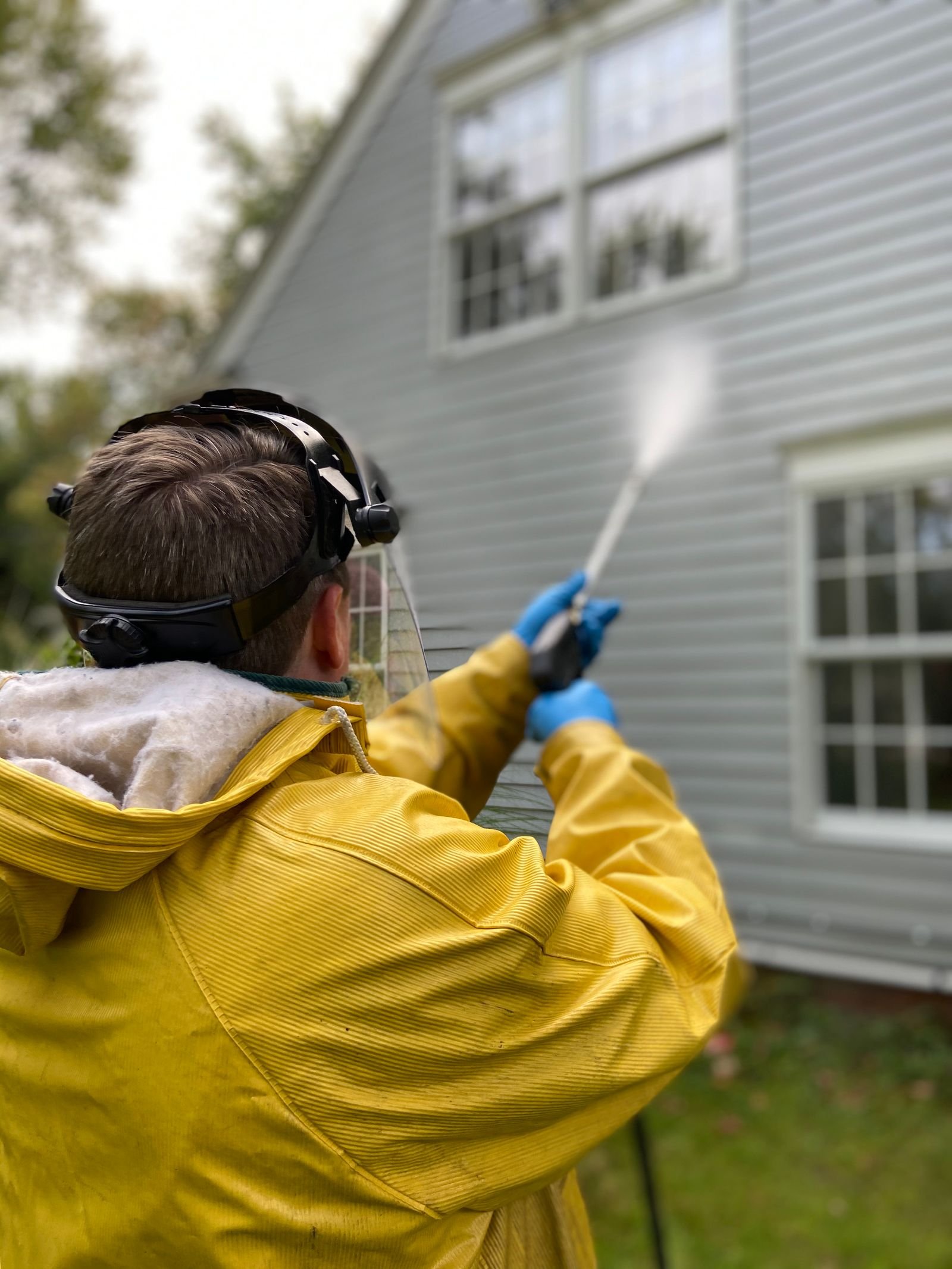 Pressure washing vinyl siding on a home exterior by KP Landscaping in Buffalo NY
