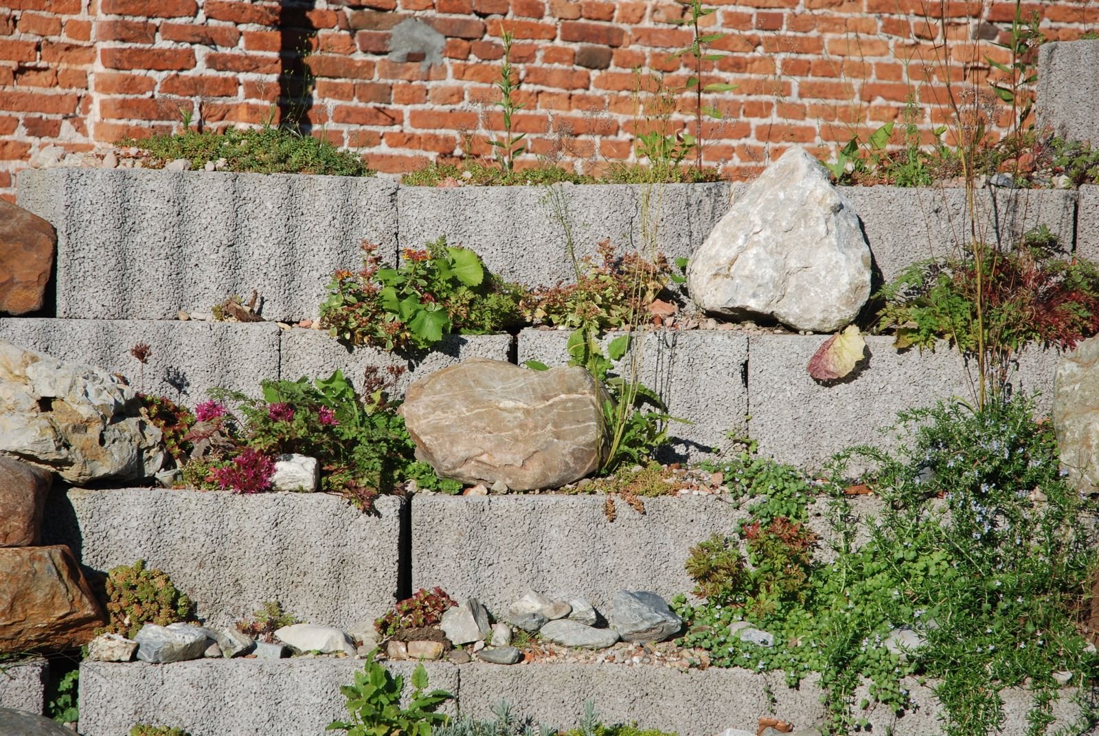 Segmental block retaining wall holding a graded slope by KP Landscaping in Buffalo NY