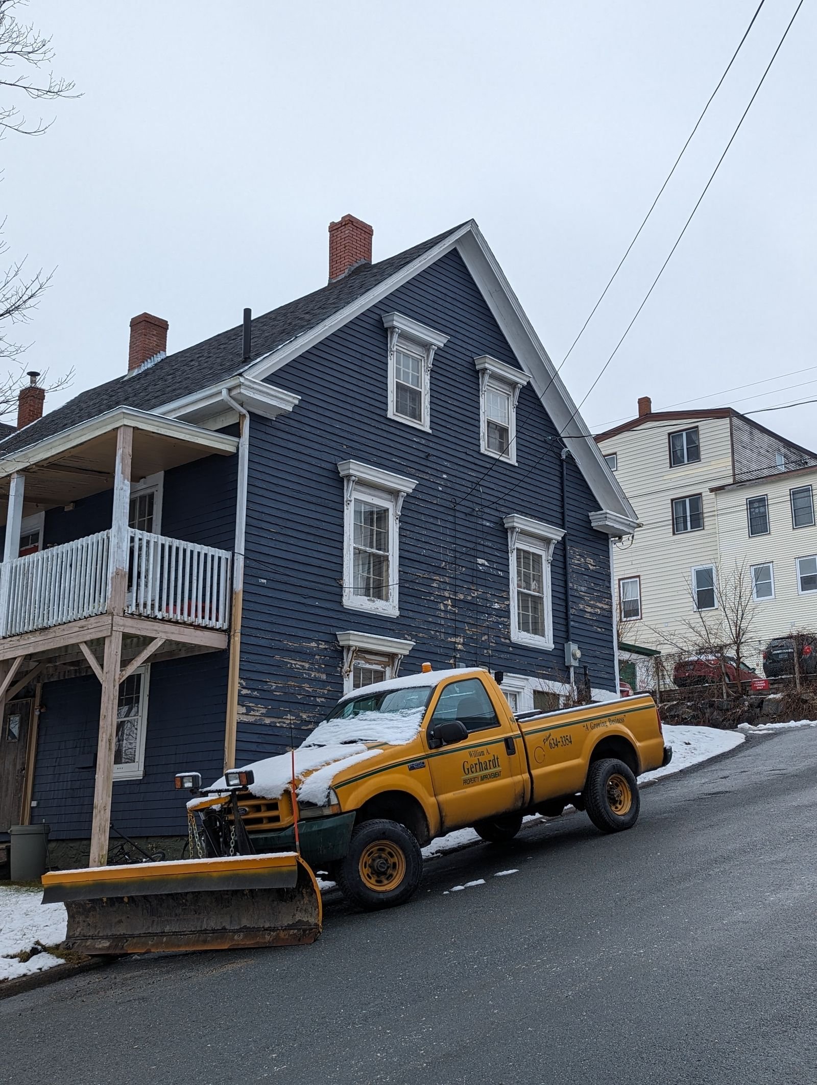 Plow truck clearing a snow covered driveway by KP Landscaping in Buffalo NY
