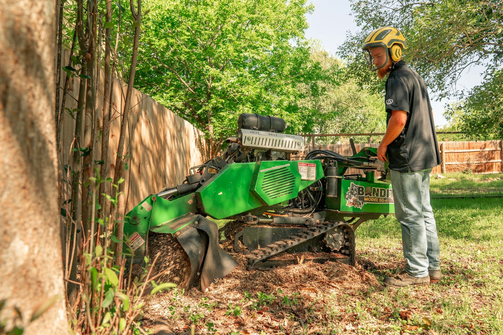 Stump grinder cutting a tree stump below grade by KP Landscaping in Buffalo NY