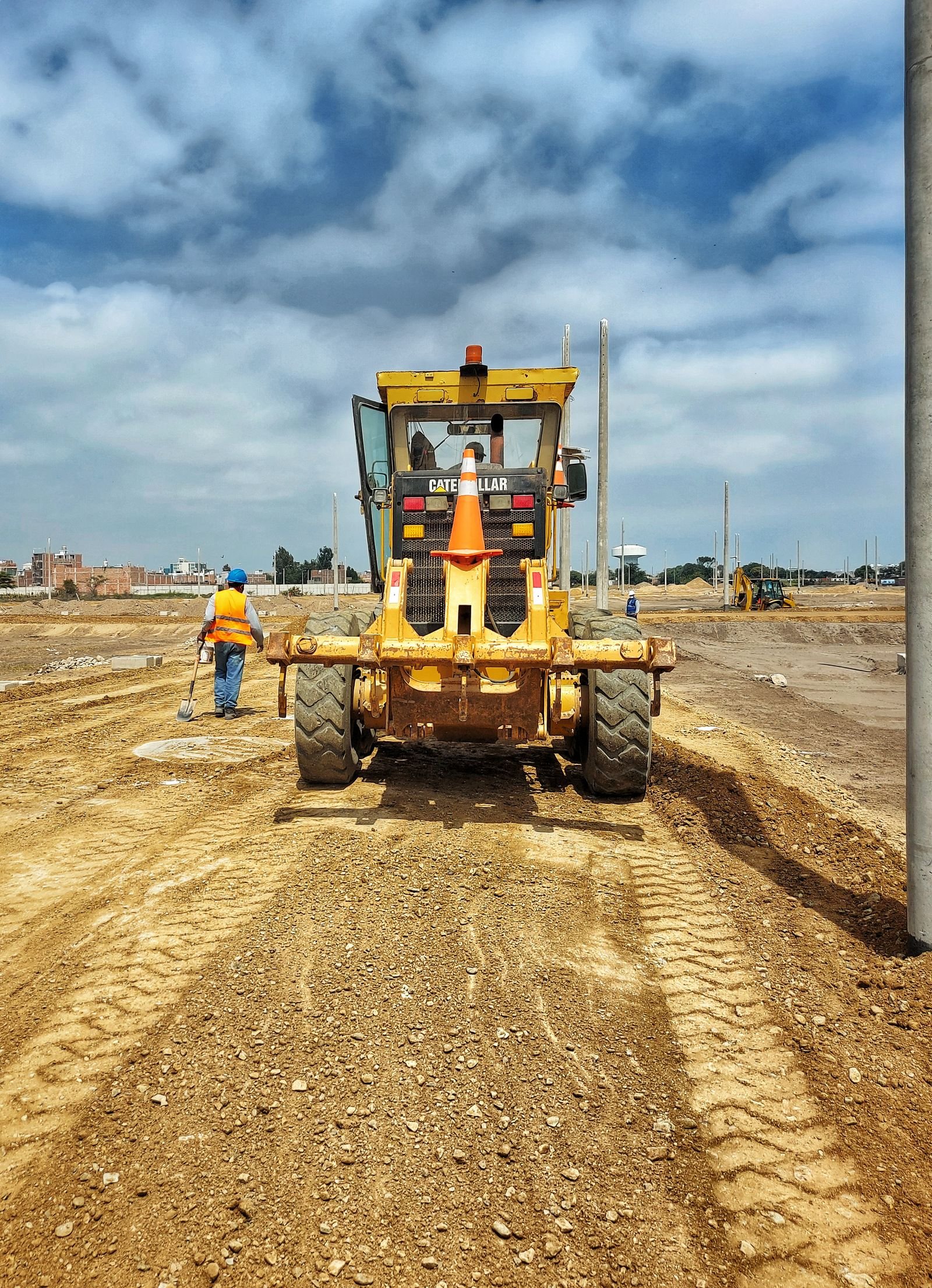 Machine grading a yard to correct drainage by KP Landscaping in Buffalo NY